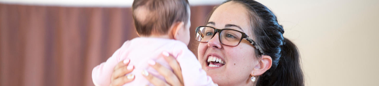 Child care worker with an infant