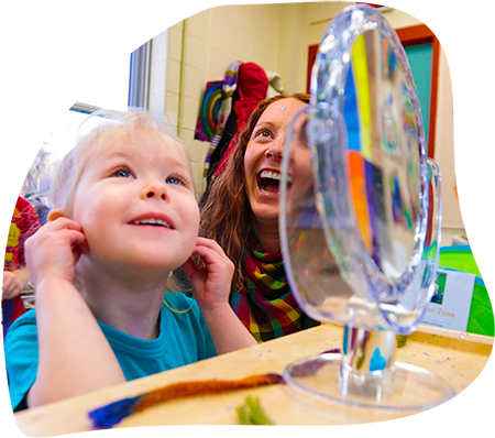 child care worker and young boy laughing